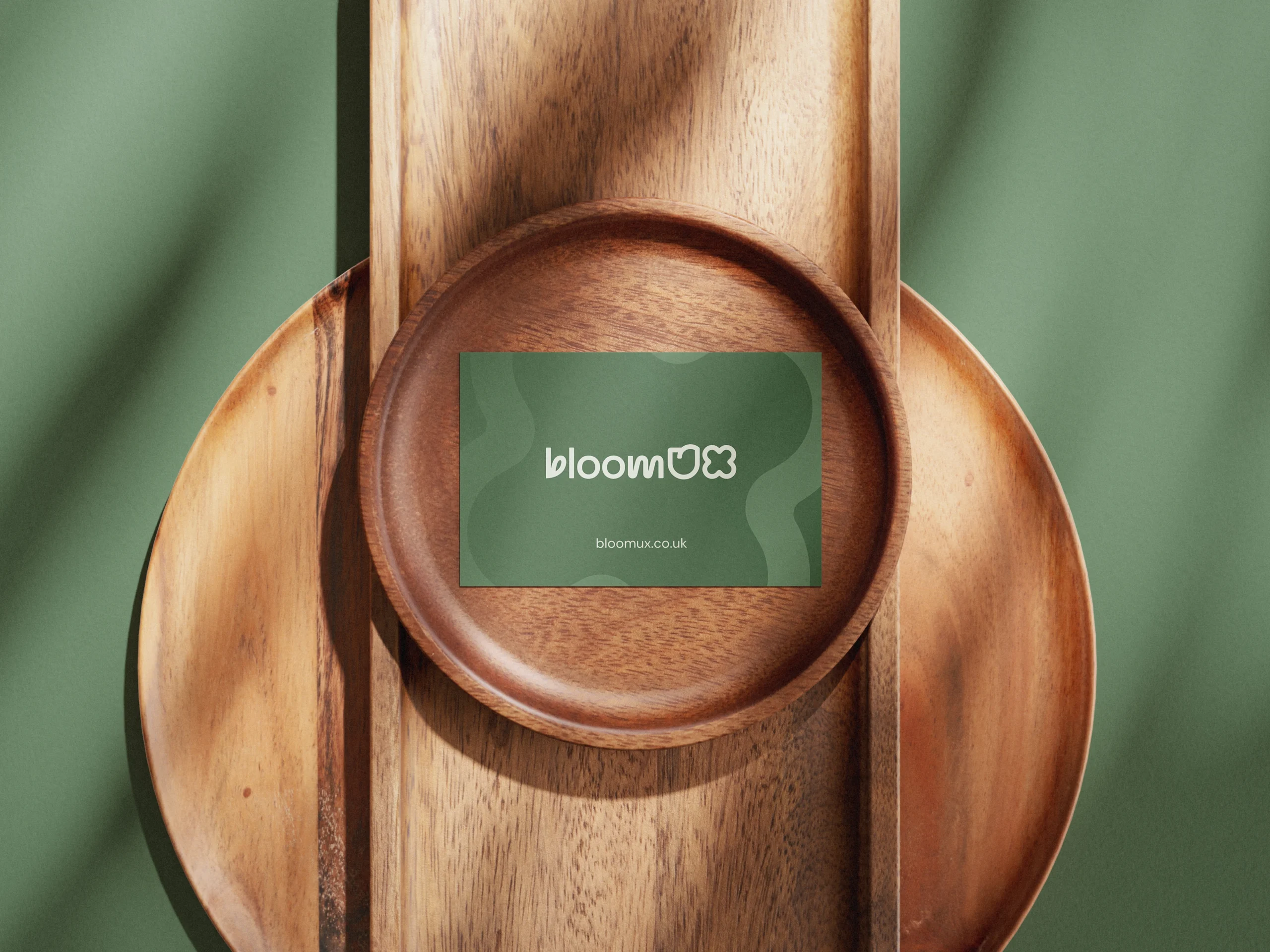 BloomUX Business card on wooden plate
