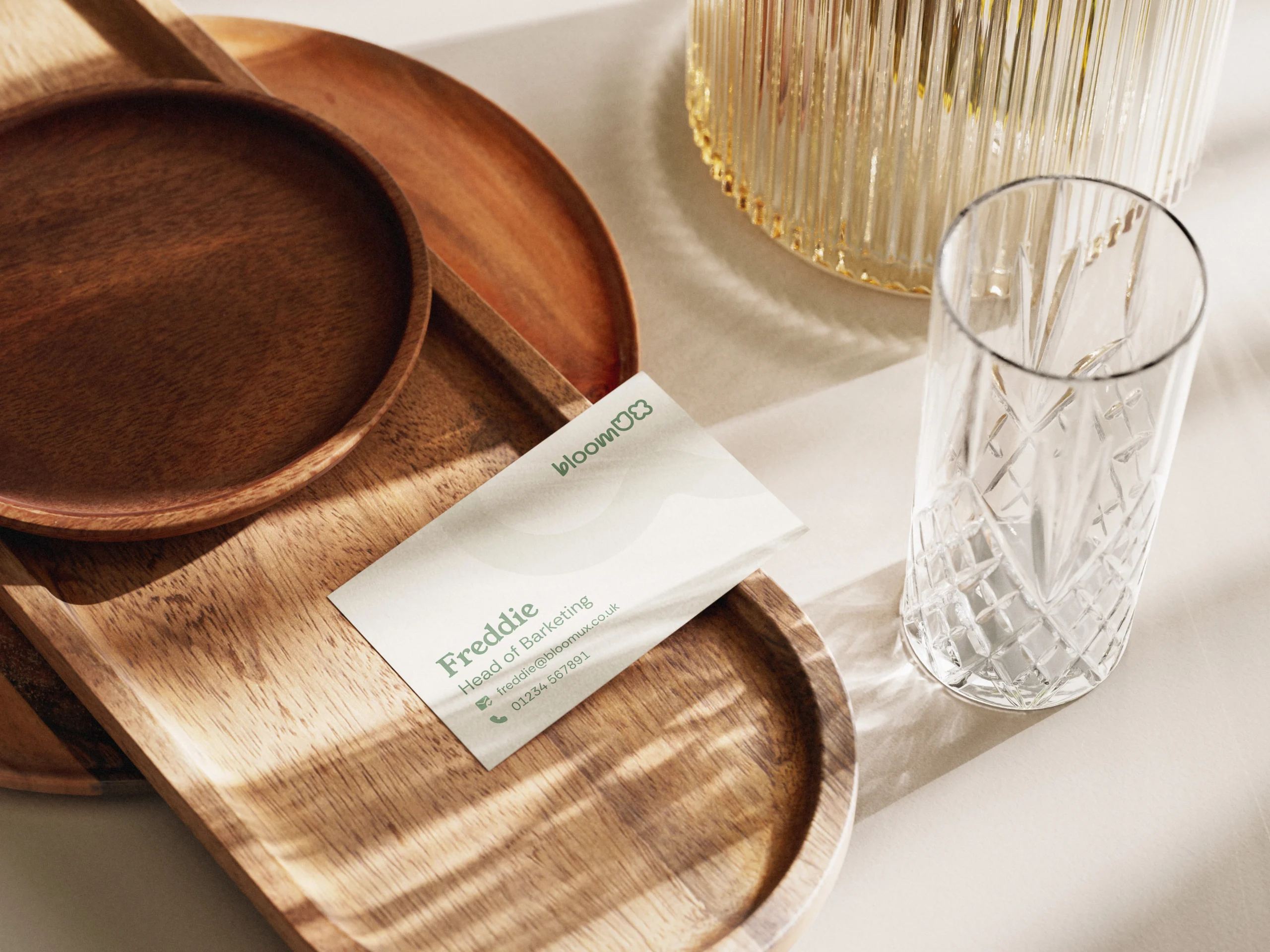 BloomUX Business card on wooden plate
